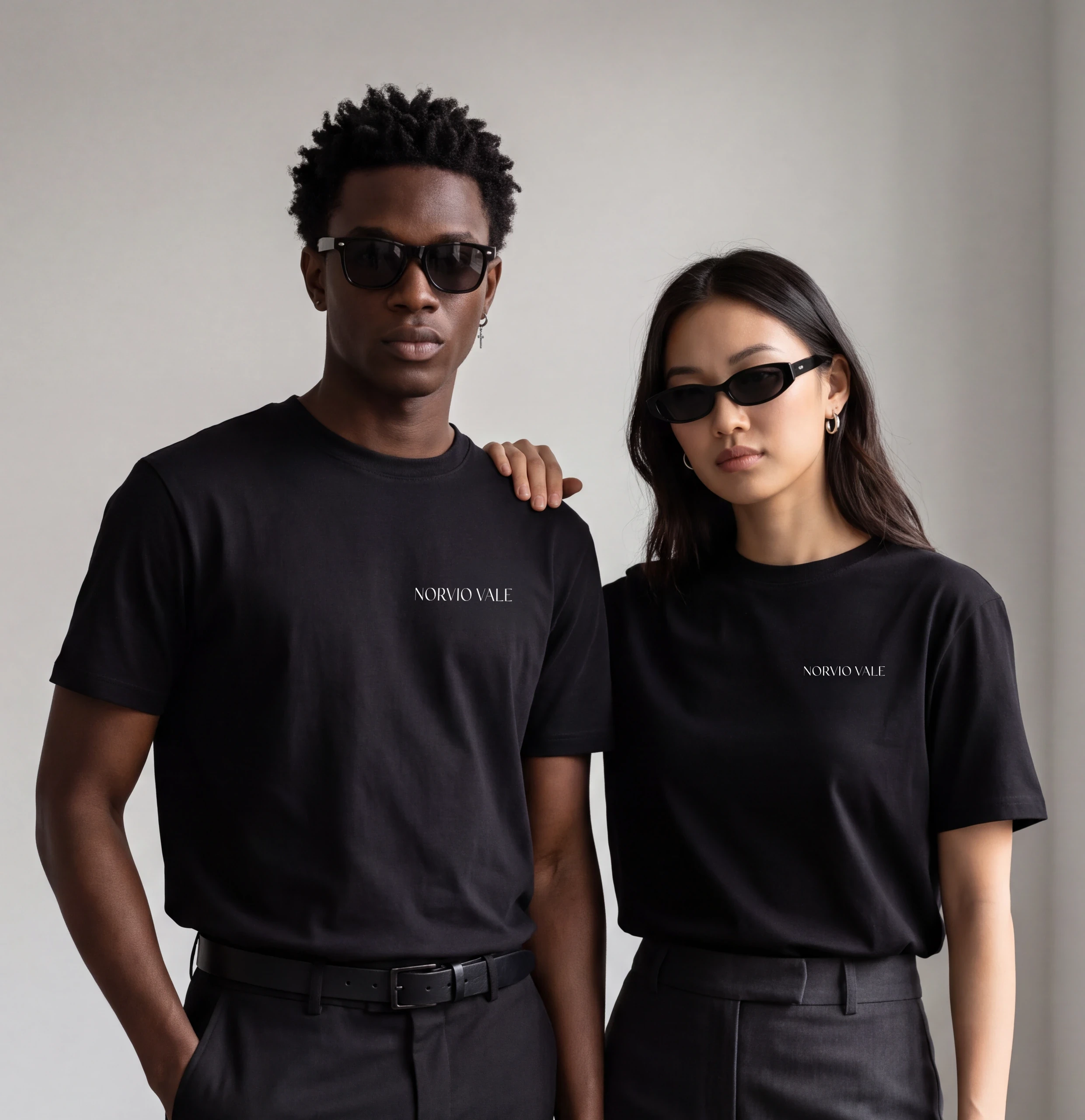 Two models wearing black Norvio Vale tees and sunglasses