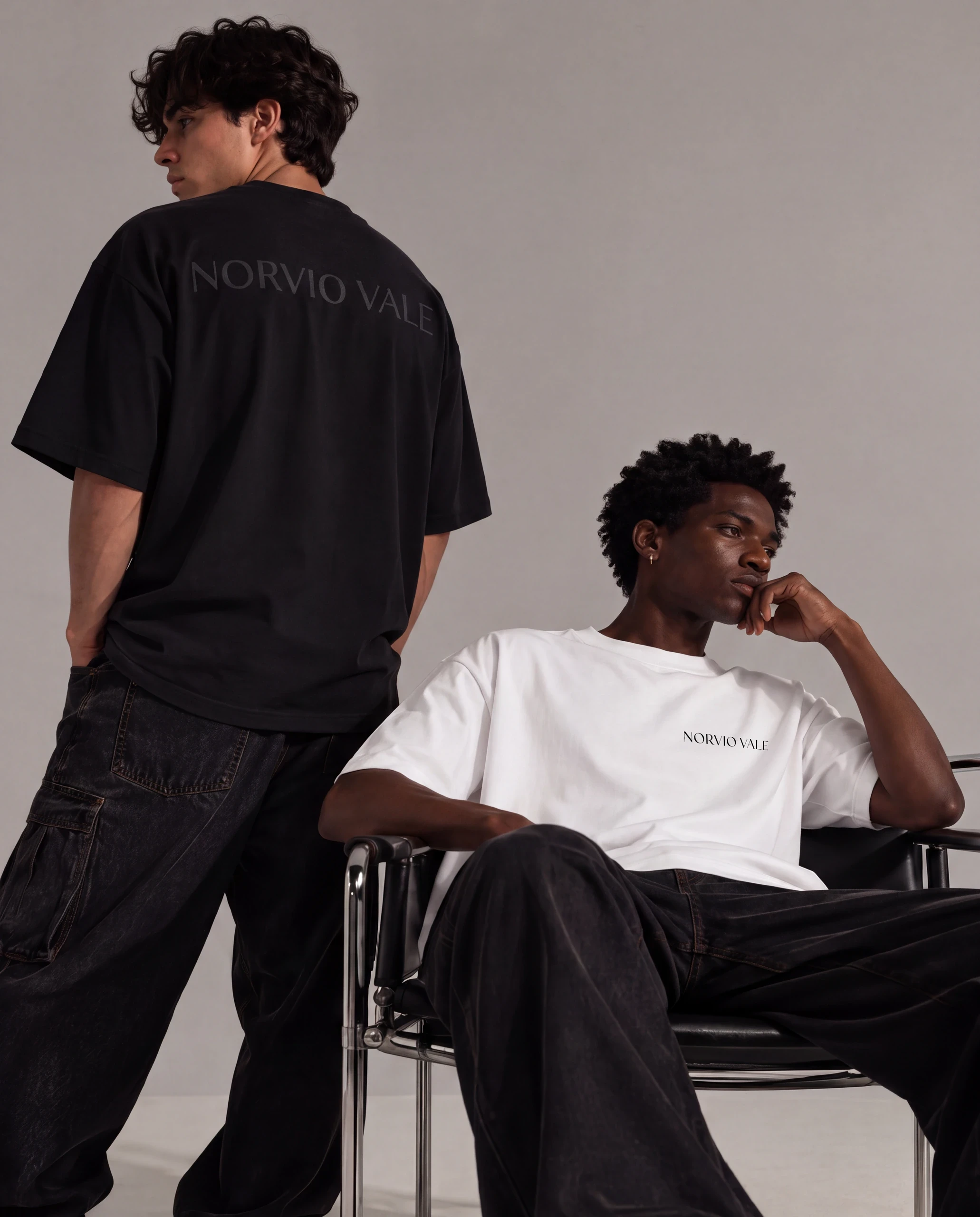 Two models in black and white Norvio Vale tees, showing the front and back details